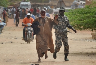 Aldjoumati Traoré est poursuivi par un militaire qui le frappe de toutes ses forces sur la tête à coups de ceinturon. Son seul crime : une allure proche de celle des fondamentalistes islamistes. © Mehdi Chebil